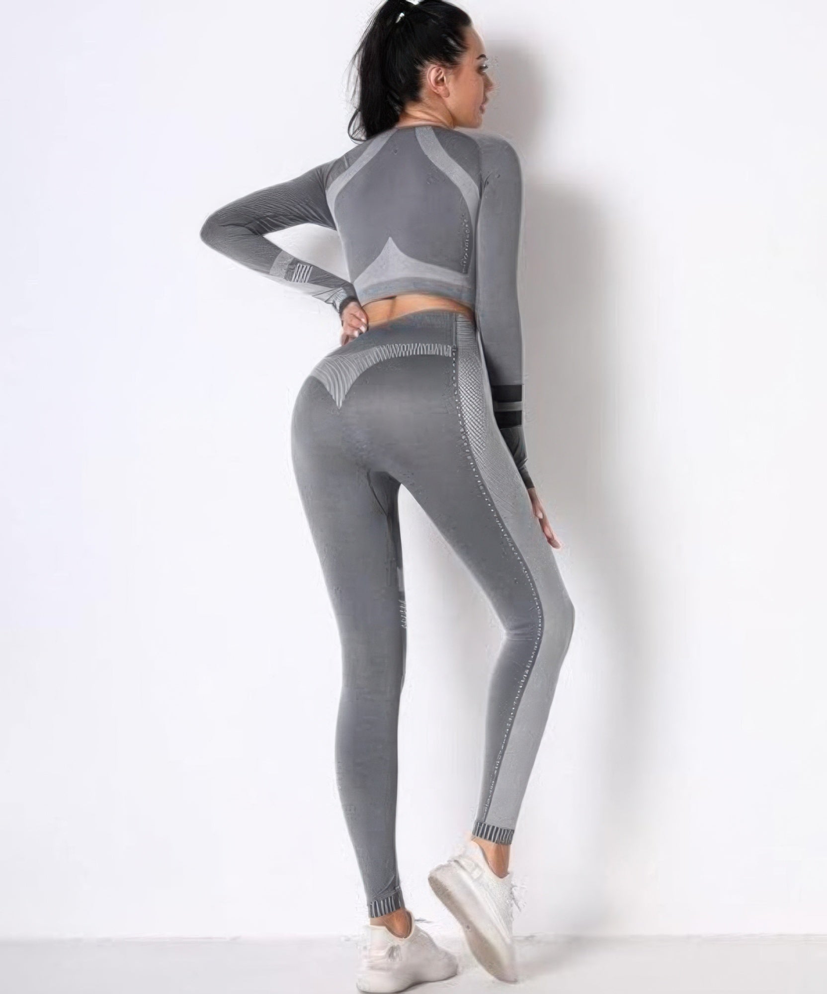 Seamless set back view, grey long-sleeve crop and leggings with striped center panel.