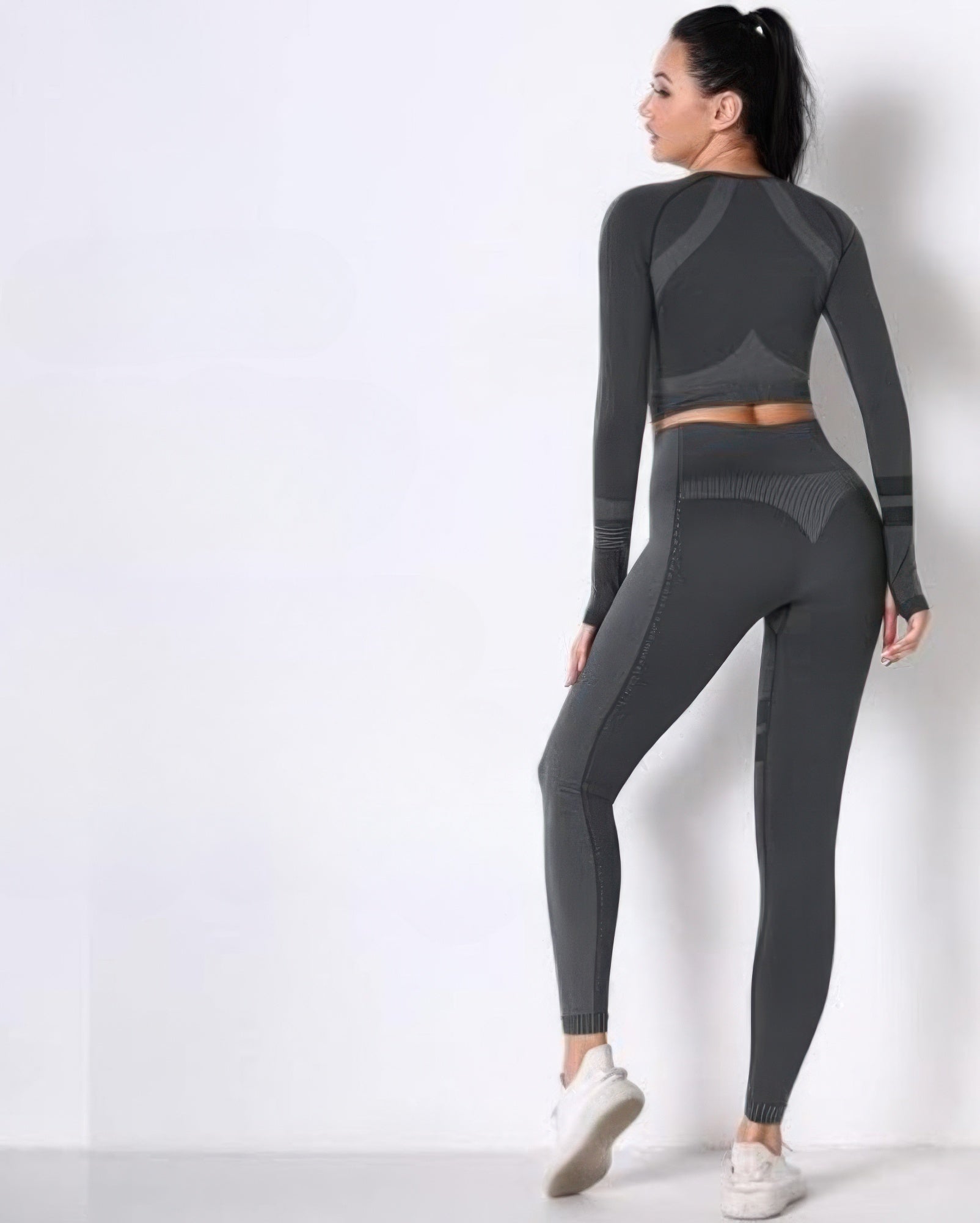 Back view: dark gray seamless long-sleeve crop top and high-waist leggings set