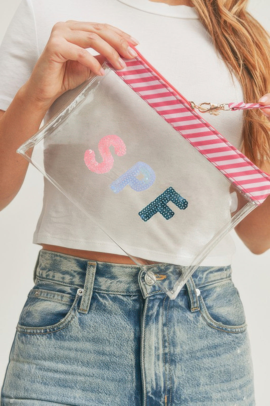 Transparent pouch with glittery S-P-F letters and pink striped wrist strap