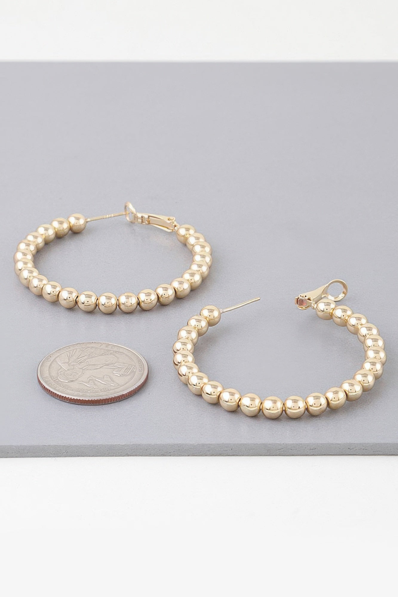 Gold-tone beaded hoop earrings with hinged hoop and small lever back
