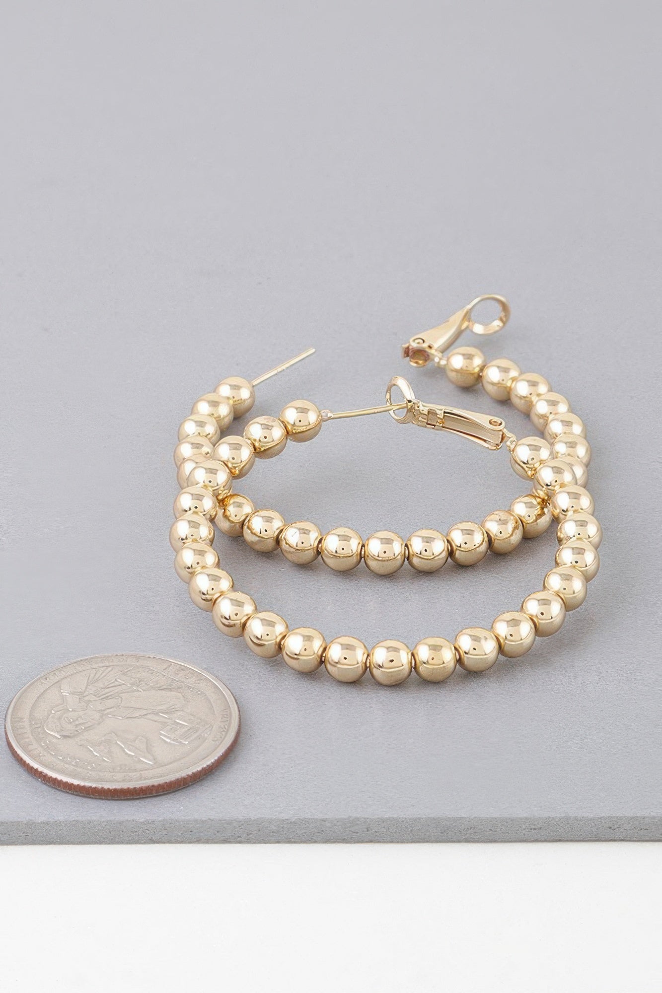 Shiny gold beaded hoop earrings, close view of hoop and lever earring back