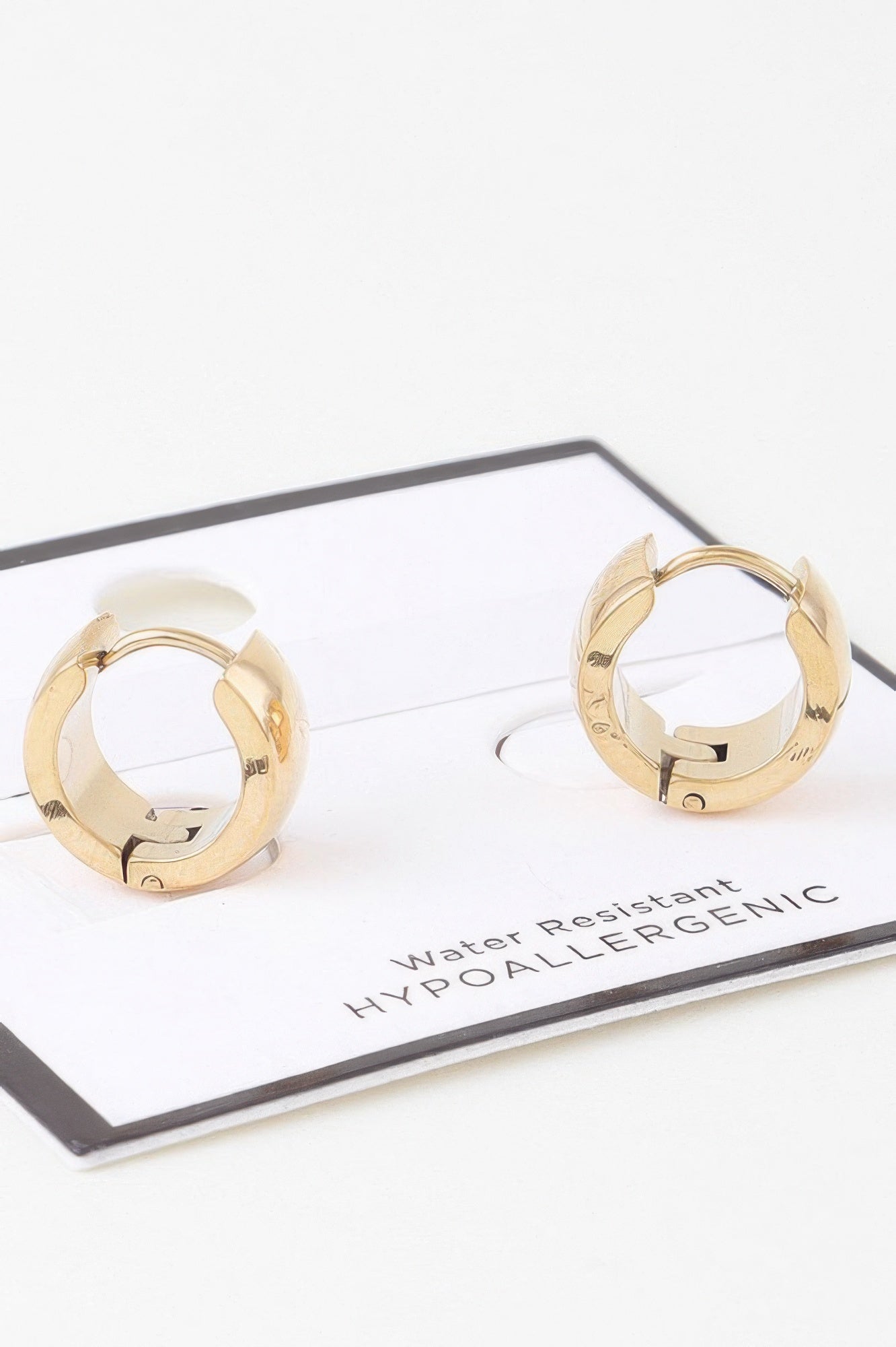 Gold bulky hoop earrings, close view of hinge and inner clasp detail