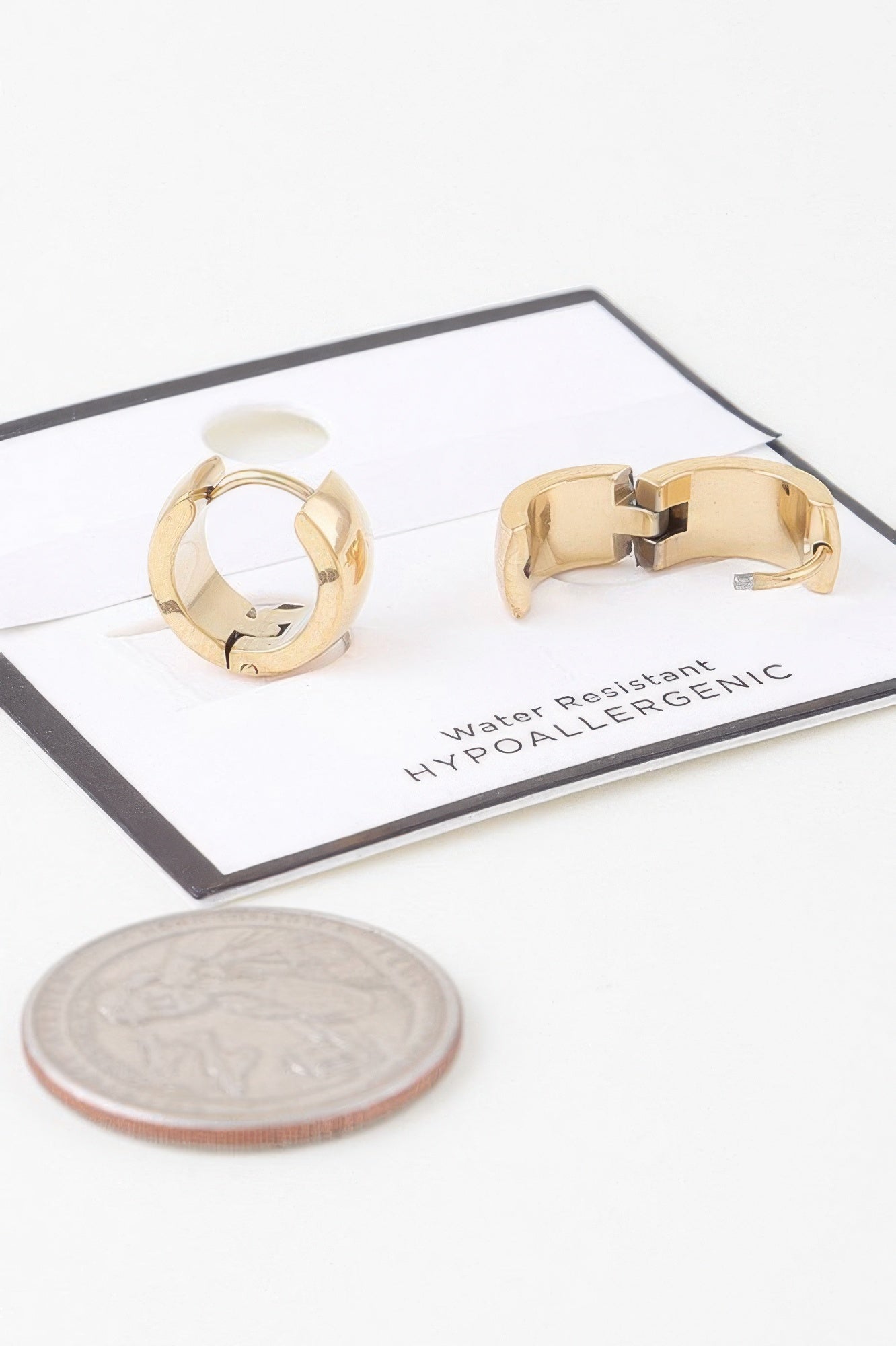 Gold hoop earrings showing front and back sides with hinged latch