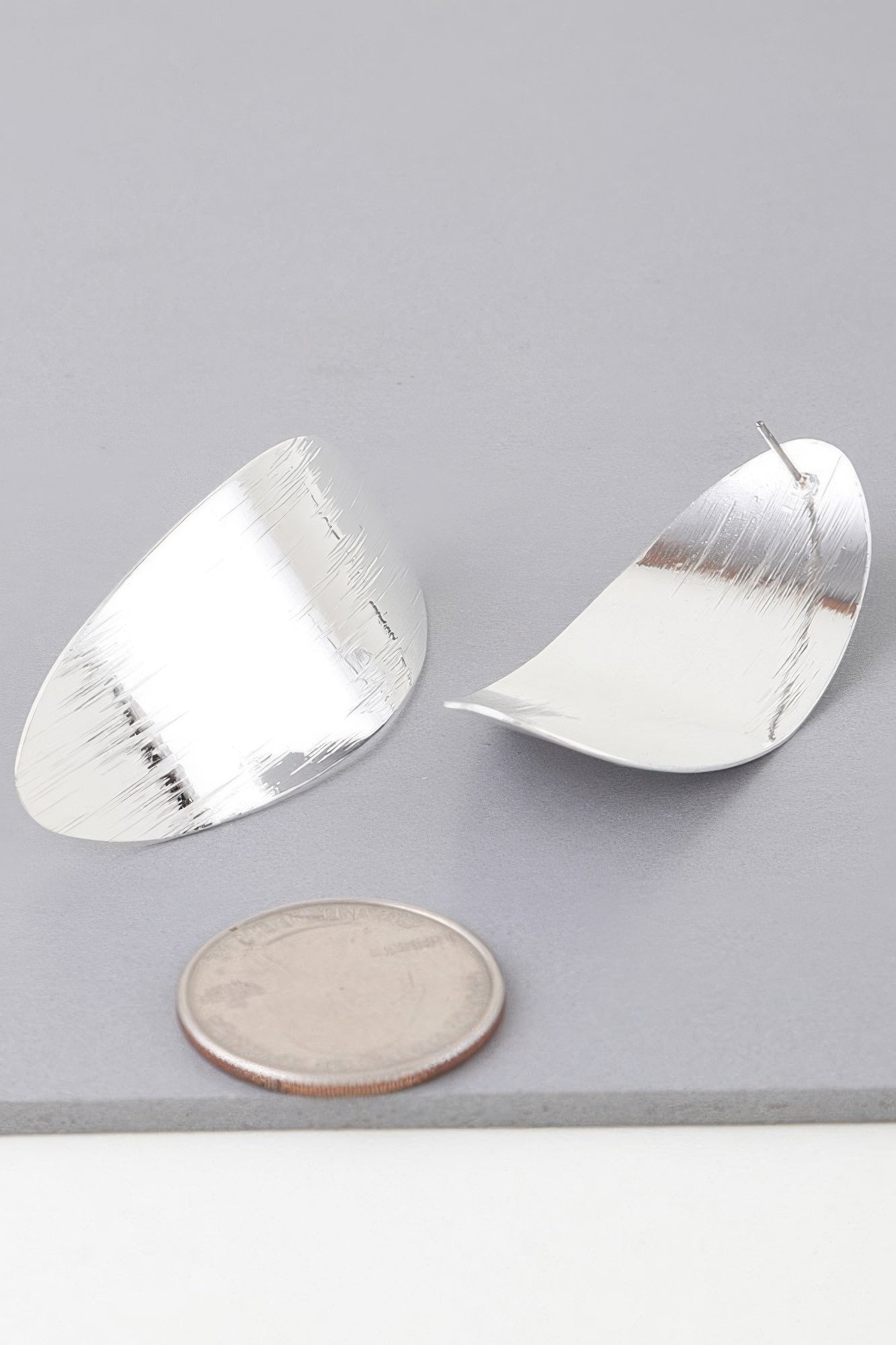 Shiny curved peel earrings in silver, smooth curved oval with stud post