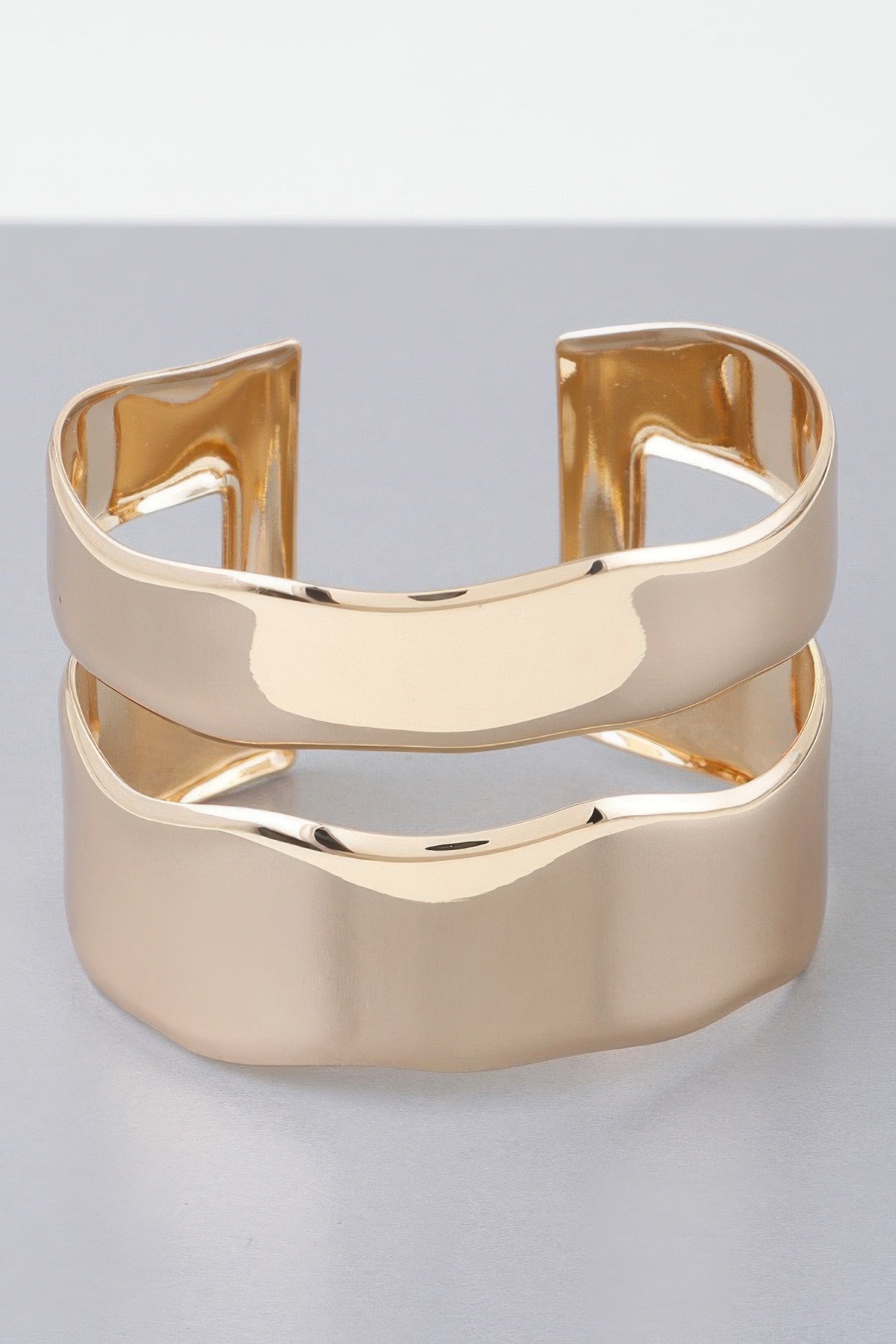 Shiny gold double open cuff bracelet with mirrored wide bands