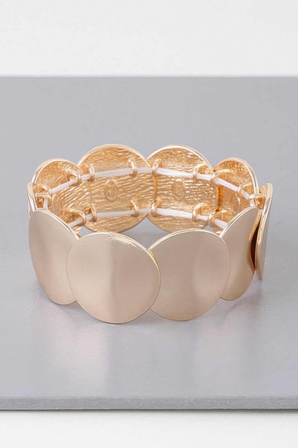 Gold flat disc plate bracelet with wide oval plates on a linked band, front view