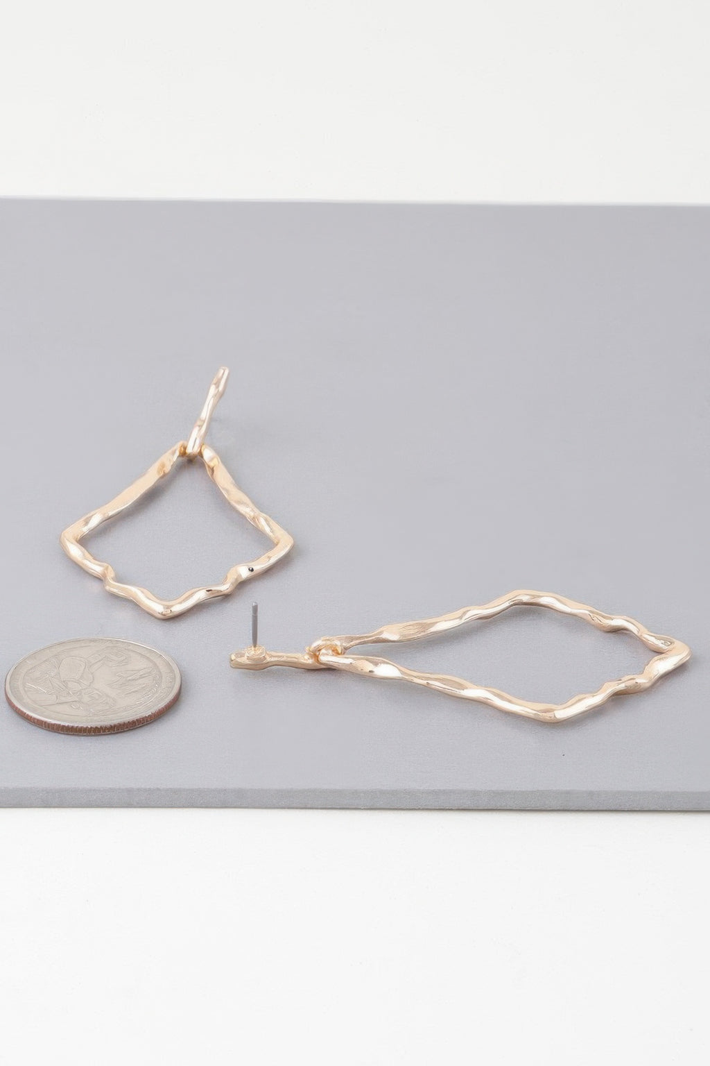 Gold tone shiny hammered kite earrings, faceted open diamond design