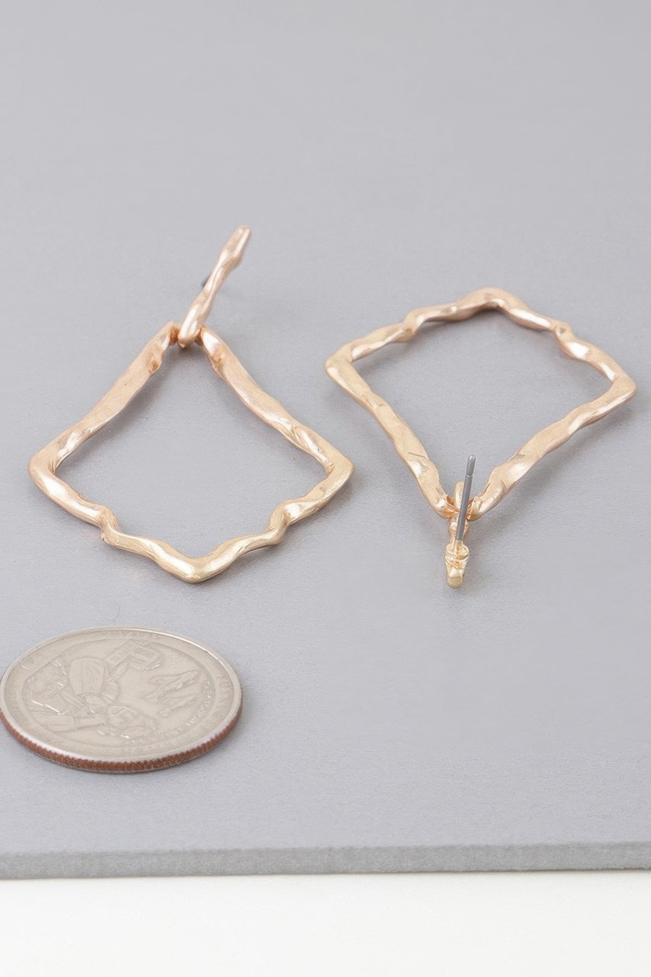 Gold tone hammered kite earrings with shiny finish, open diamond hoops