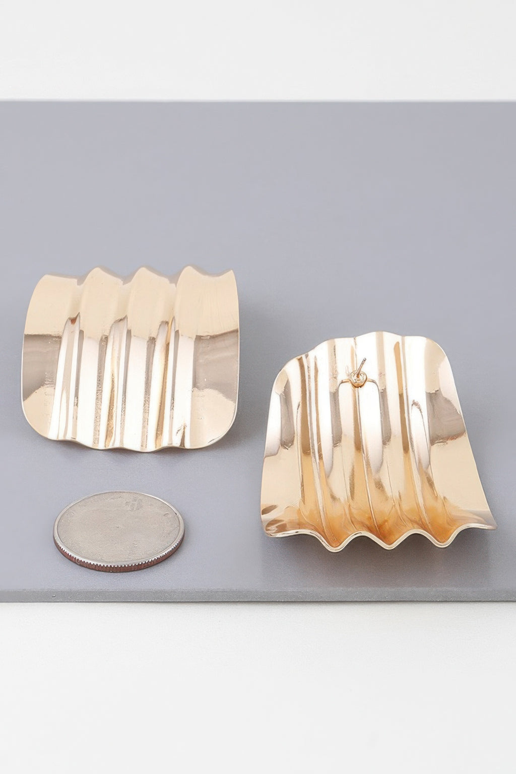 Gold ribbed curve earrings, side view with post backs and scalloped wavy shape