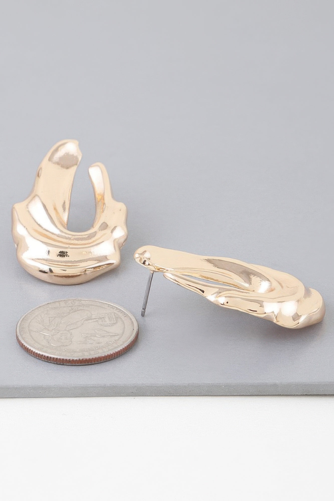 Shiny gold ripple drop earrings, long drop hoops with textured metallic sheen