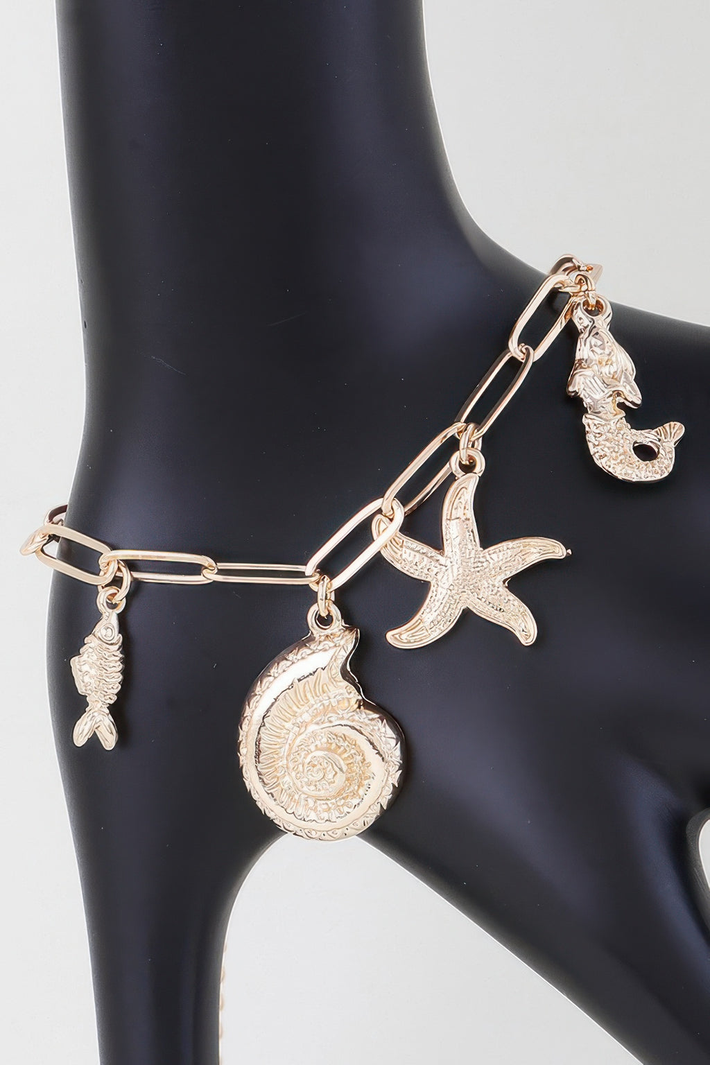 Gold-tone sea creatures charm bracelet with starfish, seashell, fish, seahorse charms