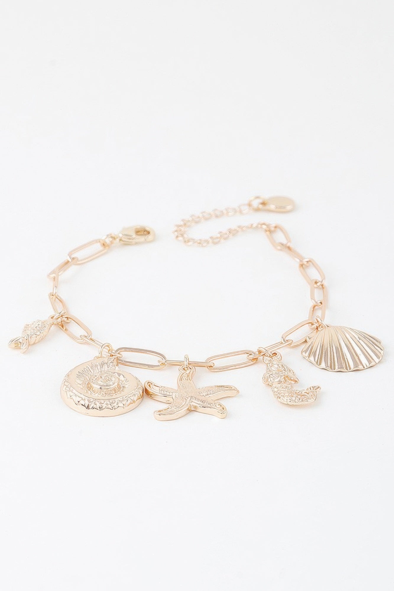 Gold sea creatures bracelet, round engraved seashell charm plus starfish and fish charms