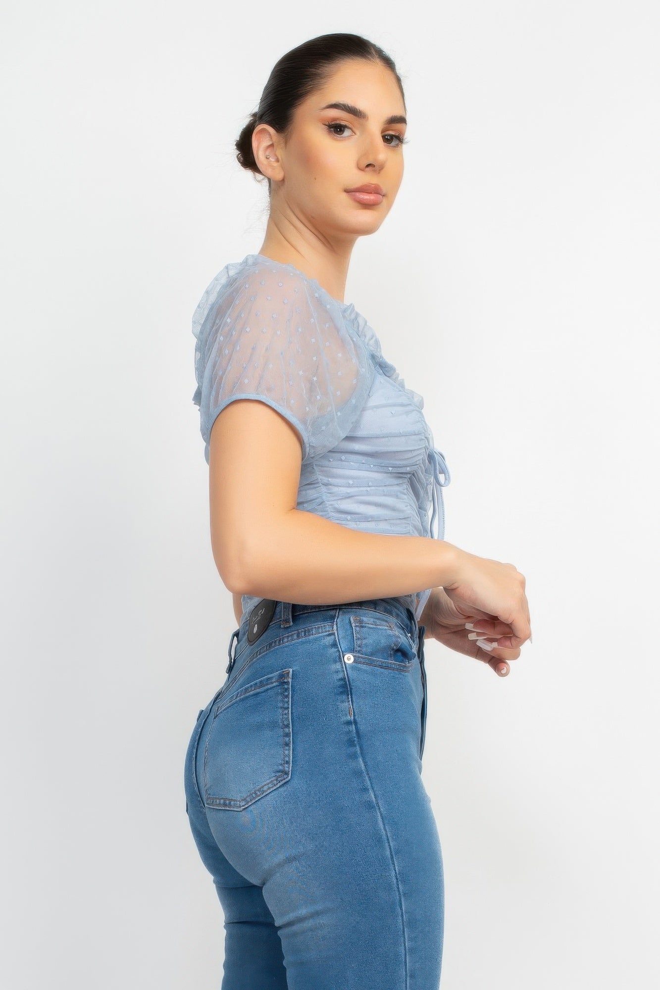 Light denim shirred mesh sleeve bodysuit, side view with tie-front lacing
