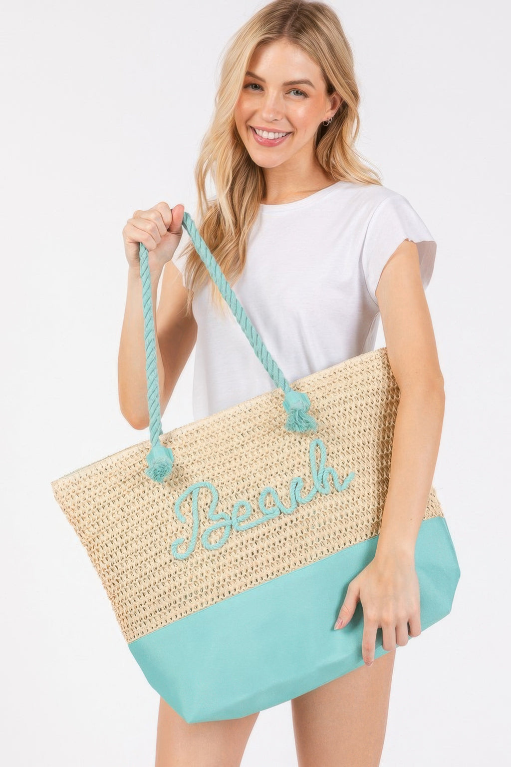 Crochet beach tote with rope handles, beige knit and teal bottom and “Beach” print