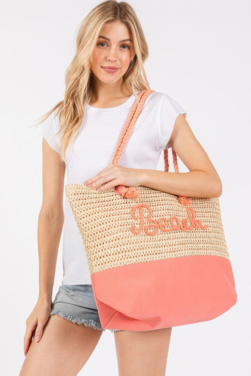 Crochet beach tote, beige knit with coral-orange bottom, rope straps and “Beach” logo