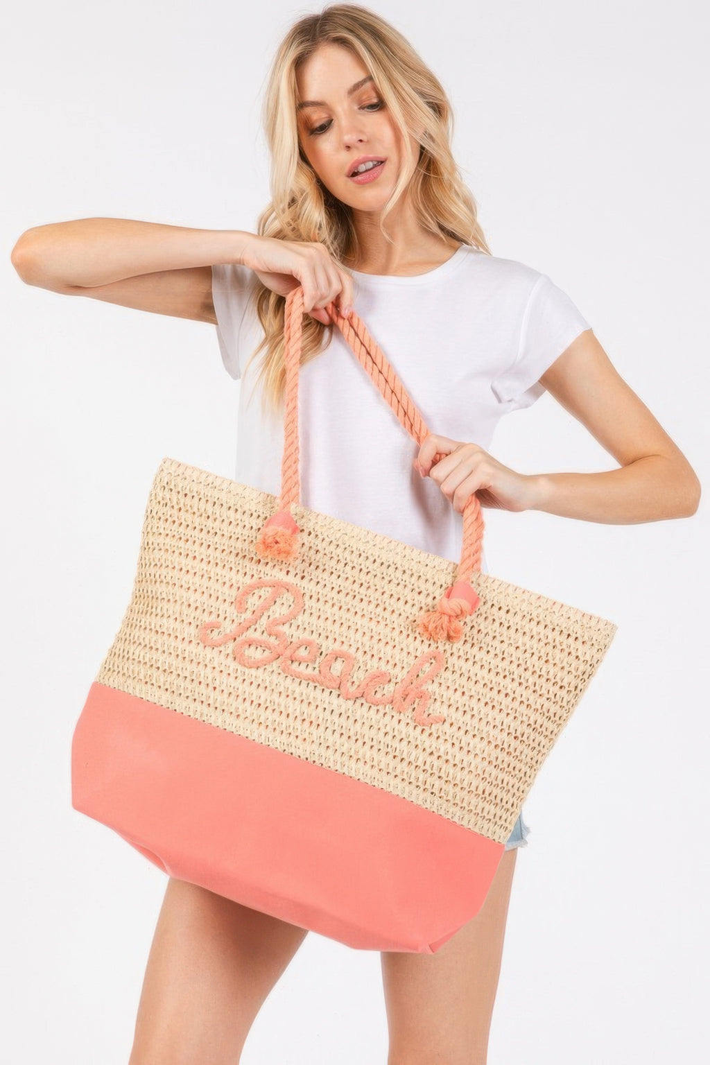 Crochet beach tote, beige knit with coral-pink bottom, braided rope handles and “Beach” print