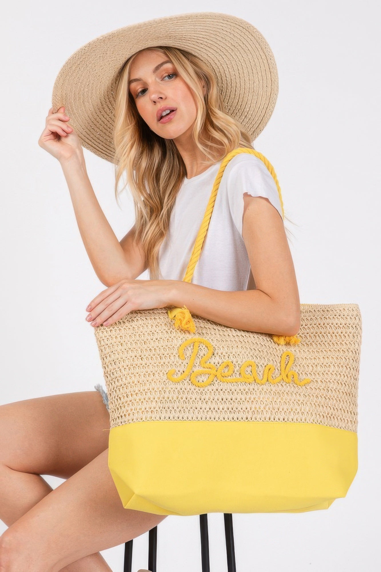 Crochet beach tote with rope straps, yellow base, 'Beach' logo in yellow