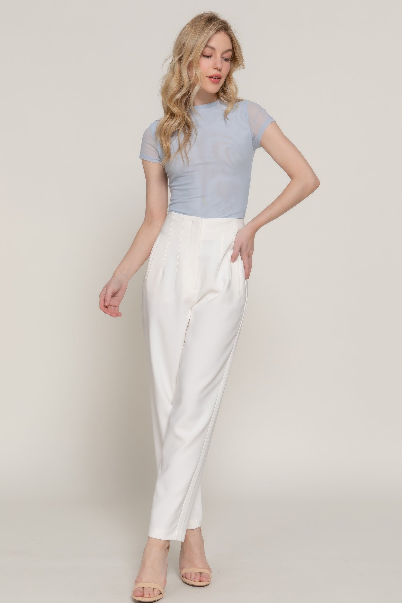 Light blue cap-sleeve 2-ply mesh top with high neckline, fitted silhouette and hem.