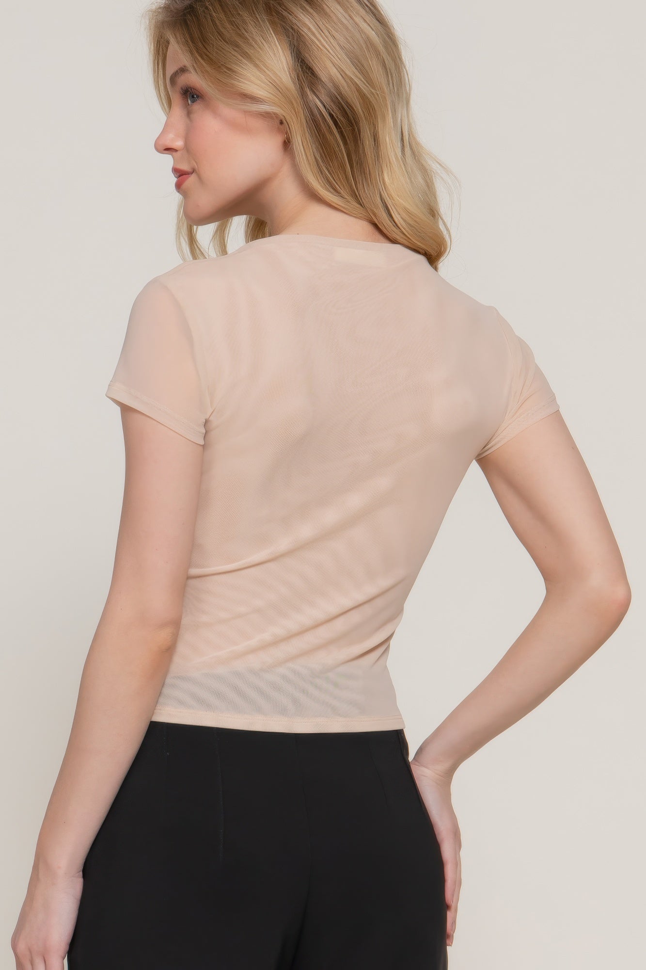 Light beige mesh top, high neckline, short cap sleeves—side back view