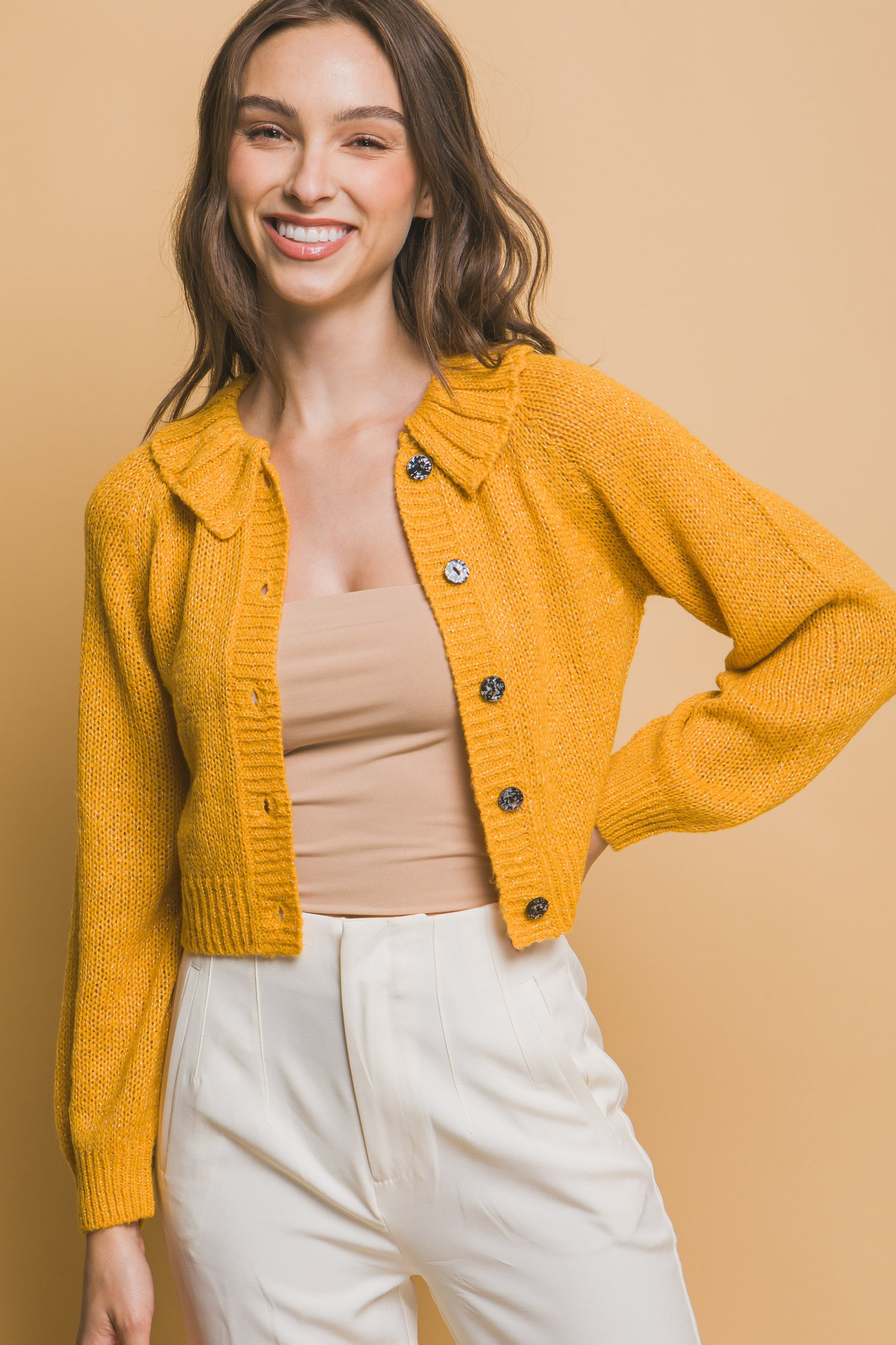 Mustard-yellow short sweater with ribbed collar and round dark buttons