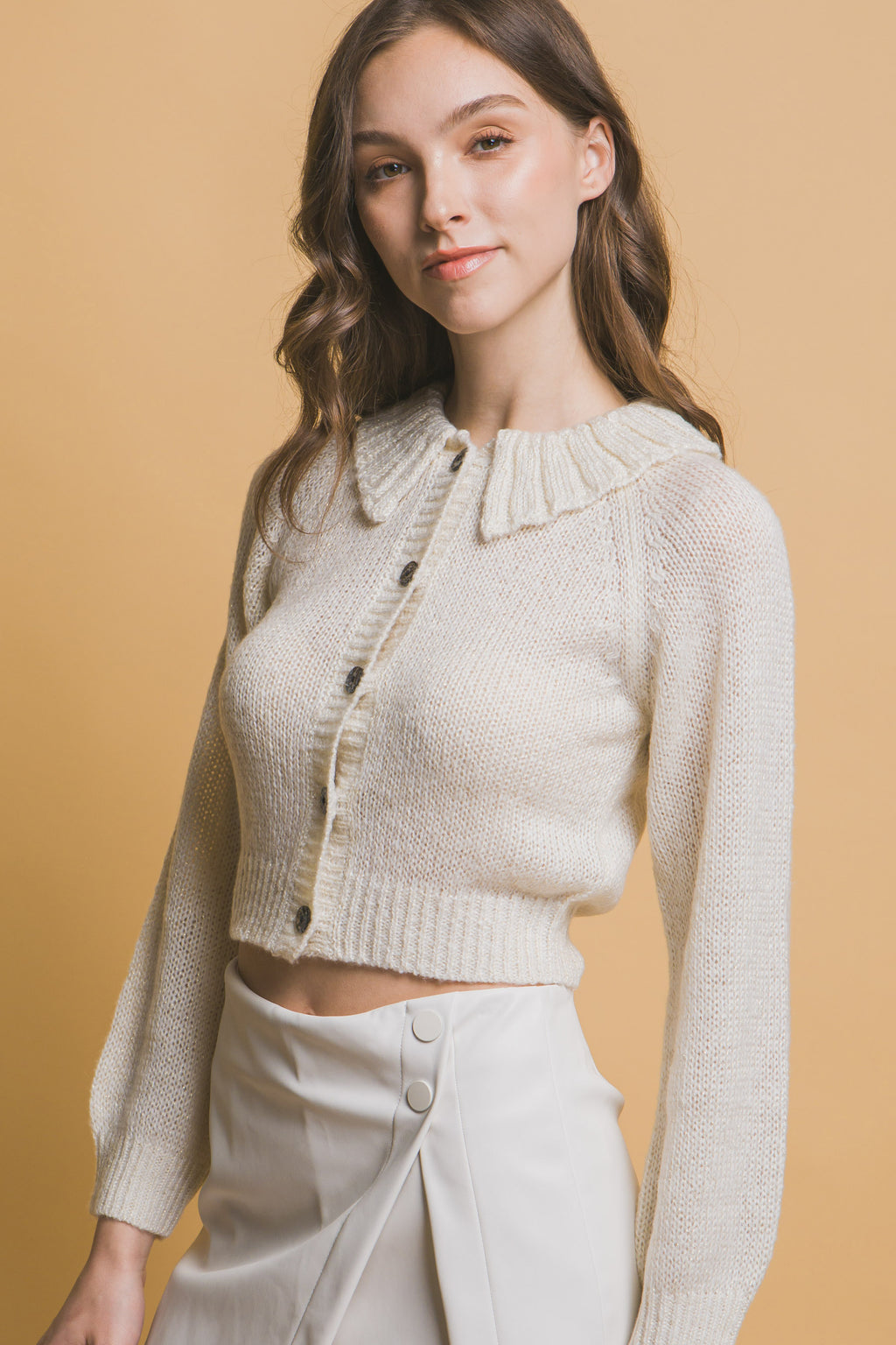 Off-white short collared sweater, textured knit with button front and fitted sleeves