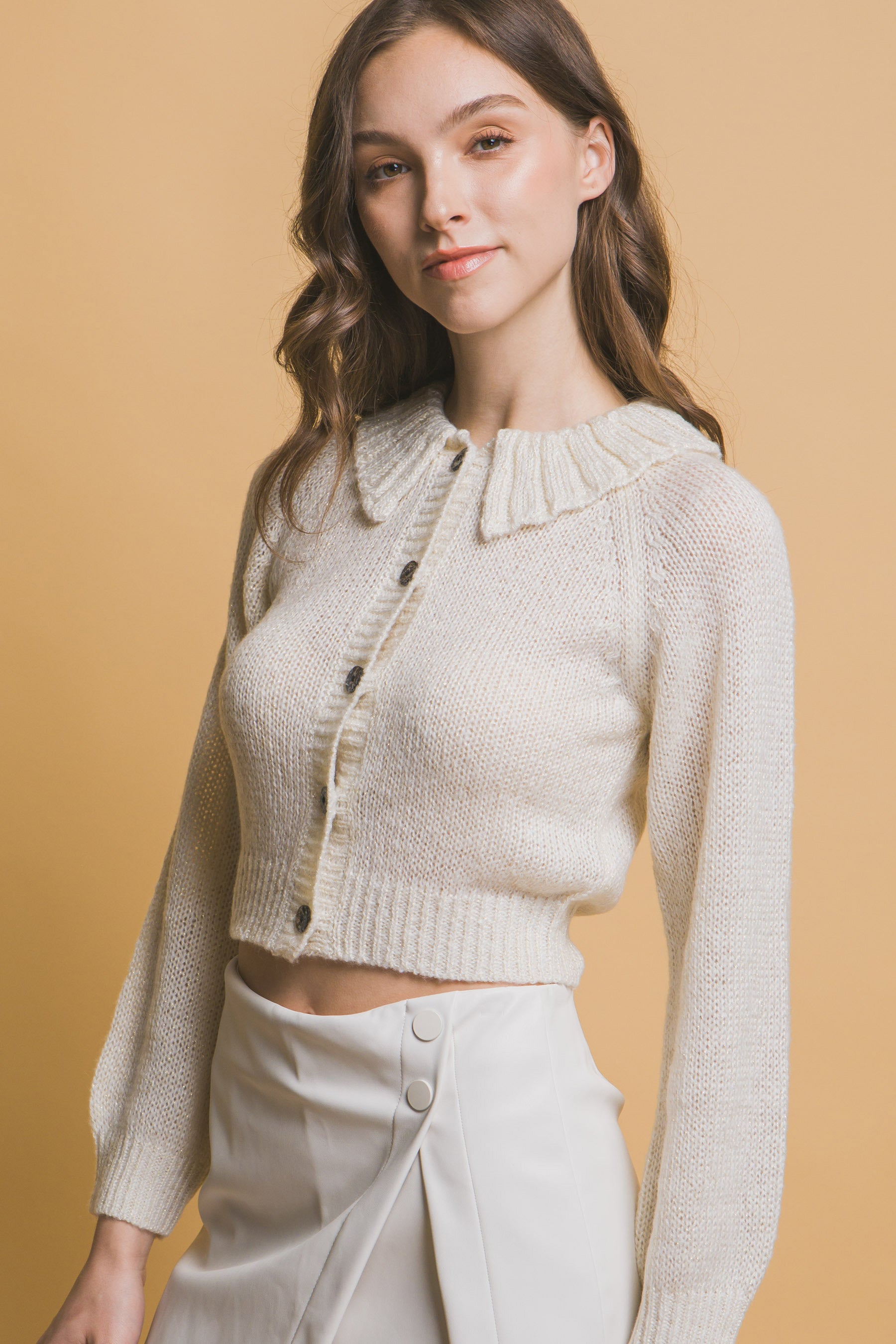 Off-white short collared sweater, textured knit with button front and fitted sleeves