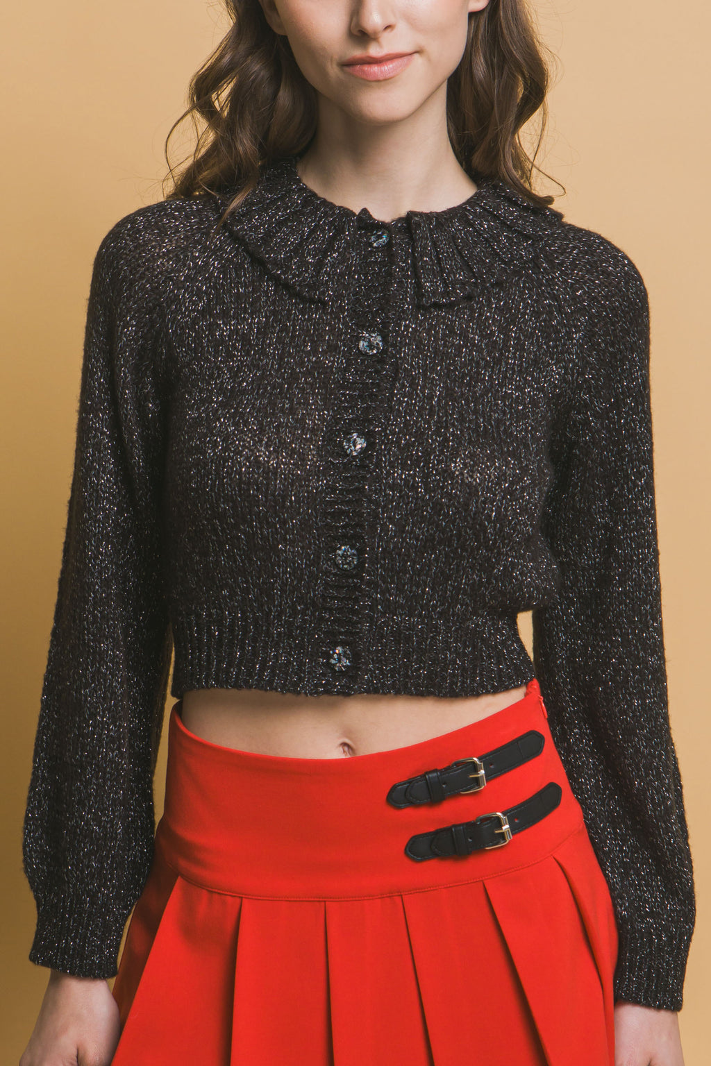 Black short collared knit sweater with central buttons and ribbed cuffs