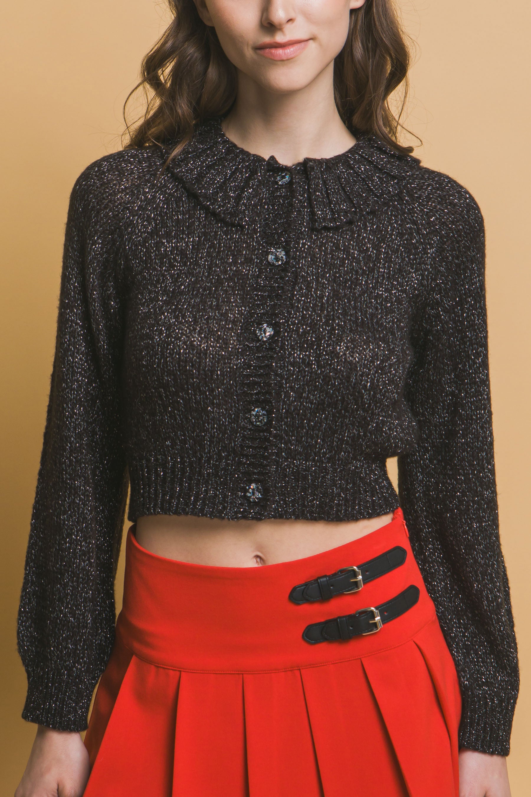 Black short collared knit sweater with central buttons and ribbed cuffs