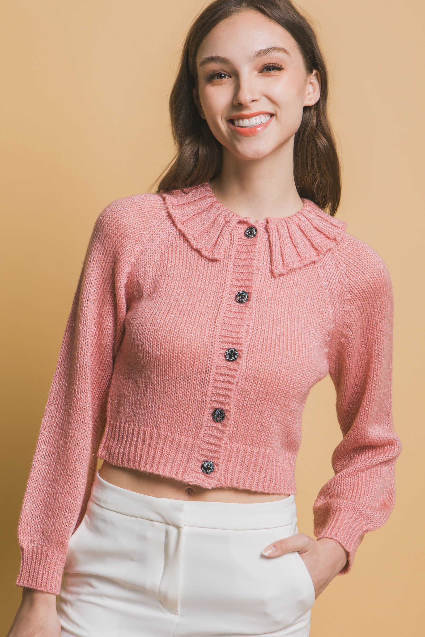 Pink cropped knit sweater with high collar and dark button front
