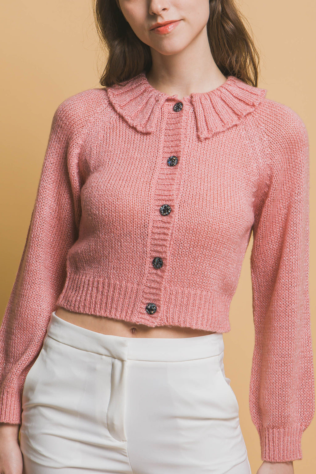 Pink cropped knit sweater front view with high collar and ribbed cuffs