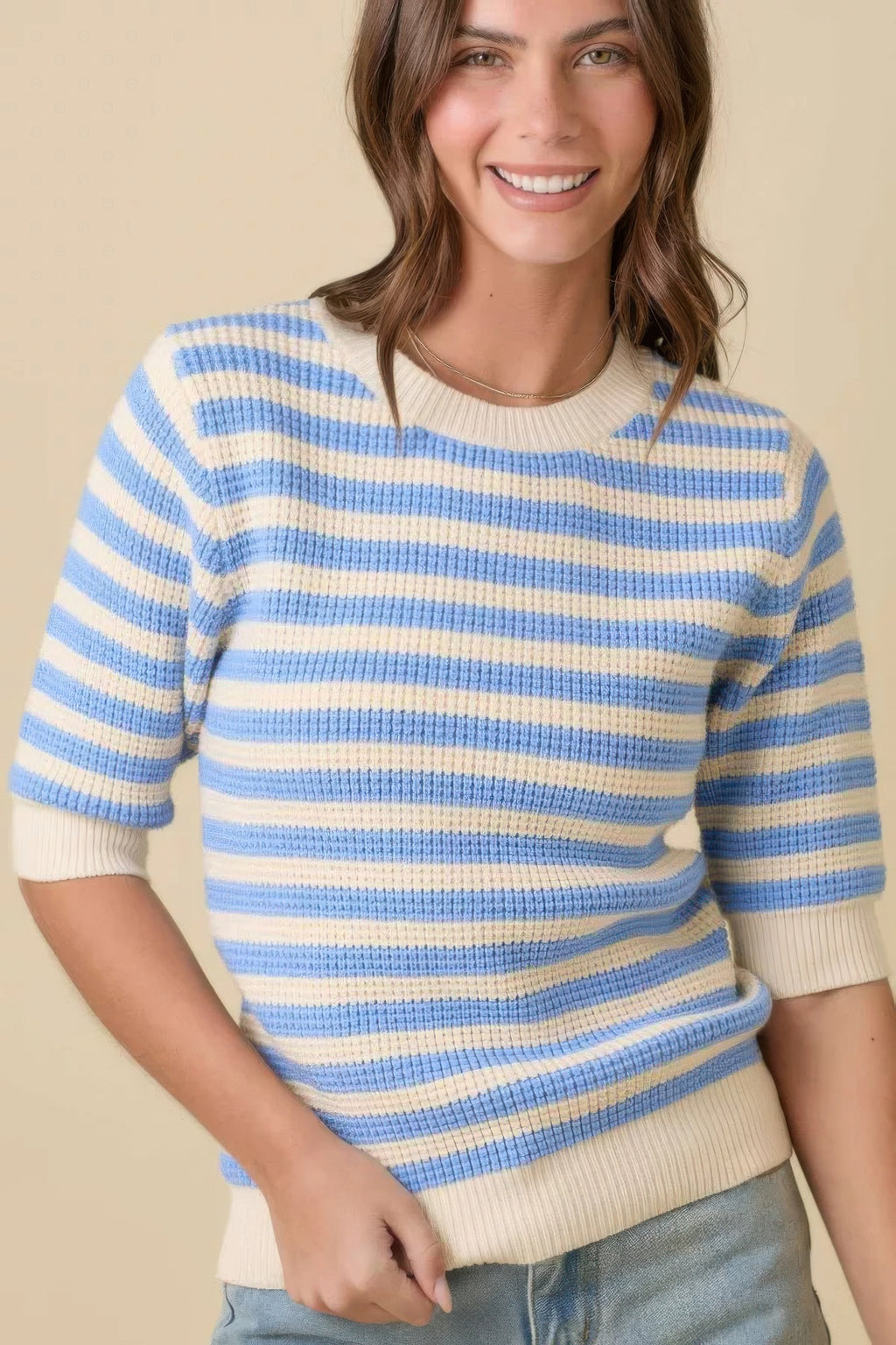 Cream/blue striped knit sweater top, short sleeves, ribbed trim, close 3/4 view