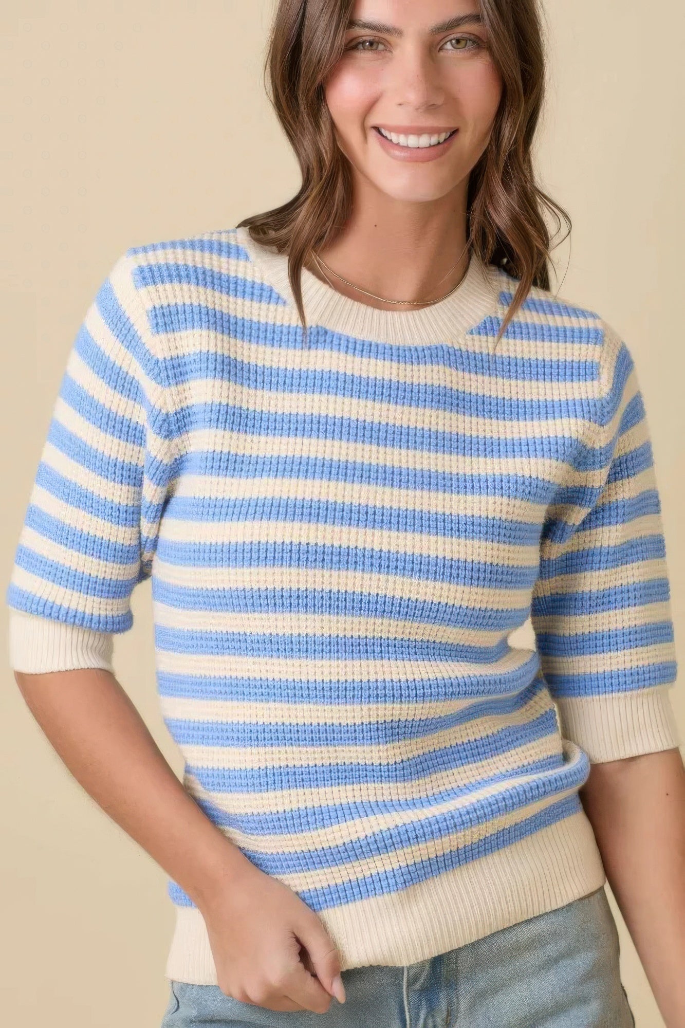 Cream/blue striped knit sweater top, short sleeves, ribbed trim, close 3/4 view