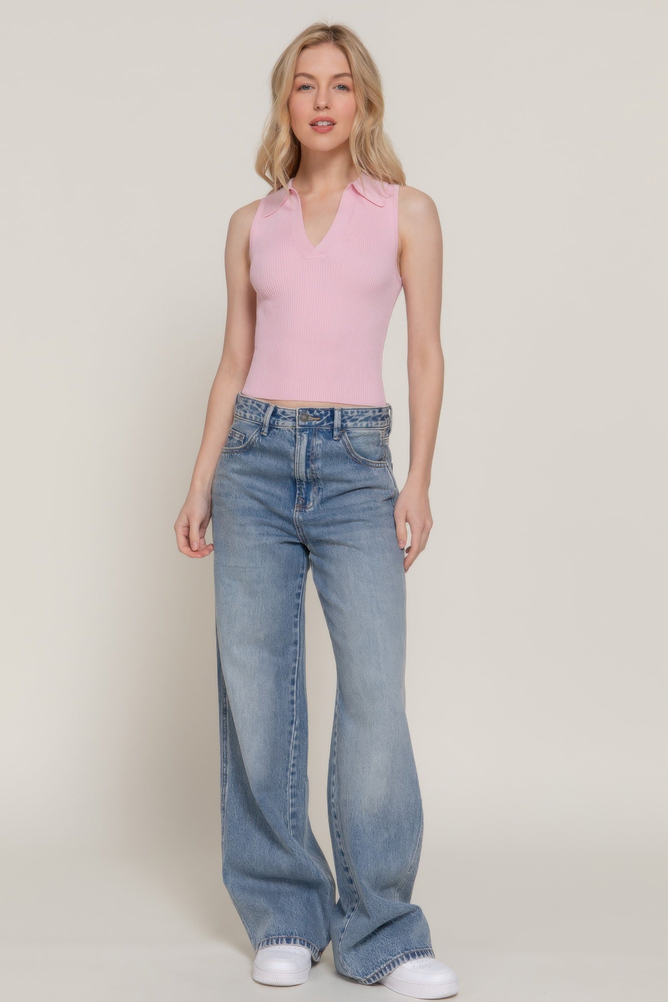 Pale pink sleeveless polo spring sweater, ribbed knit V-neck collar, cropped length