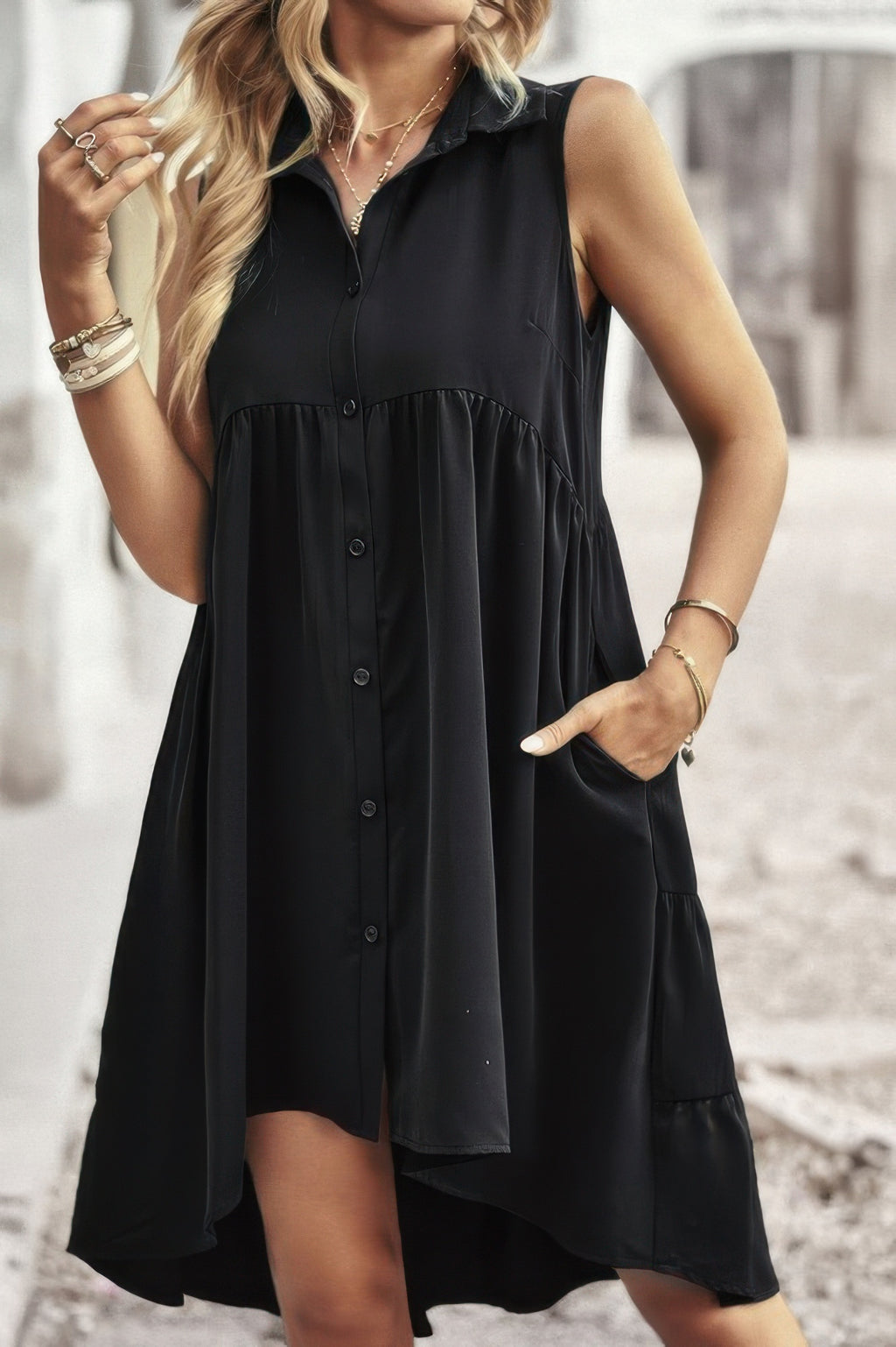 Black sleeveless solid peplum shirt dress, button placket and layered ruffle hem