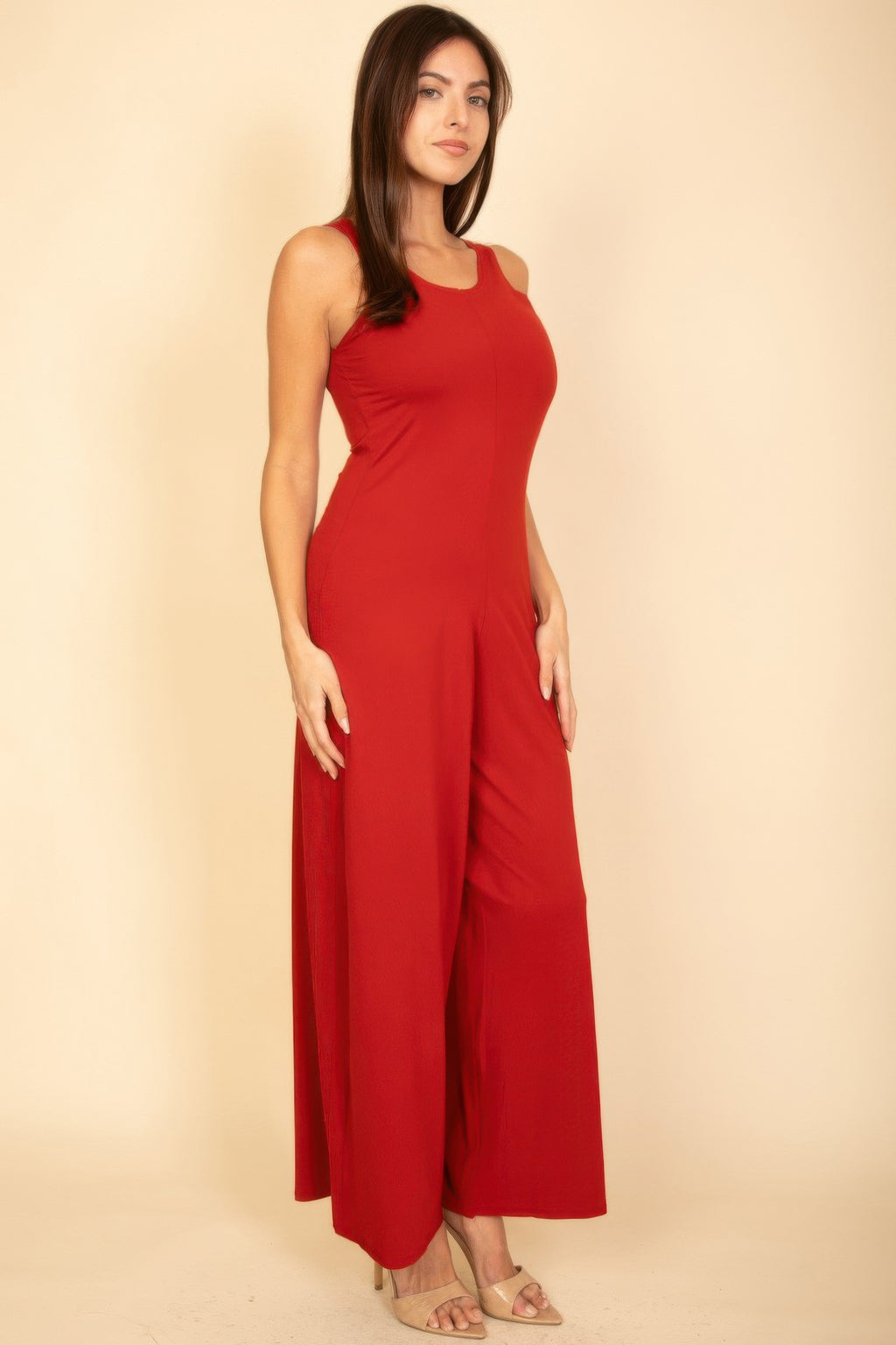 Red sleeveless wide-leg jumpsuit with slim torso and flowing wide bottoms