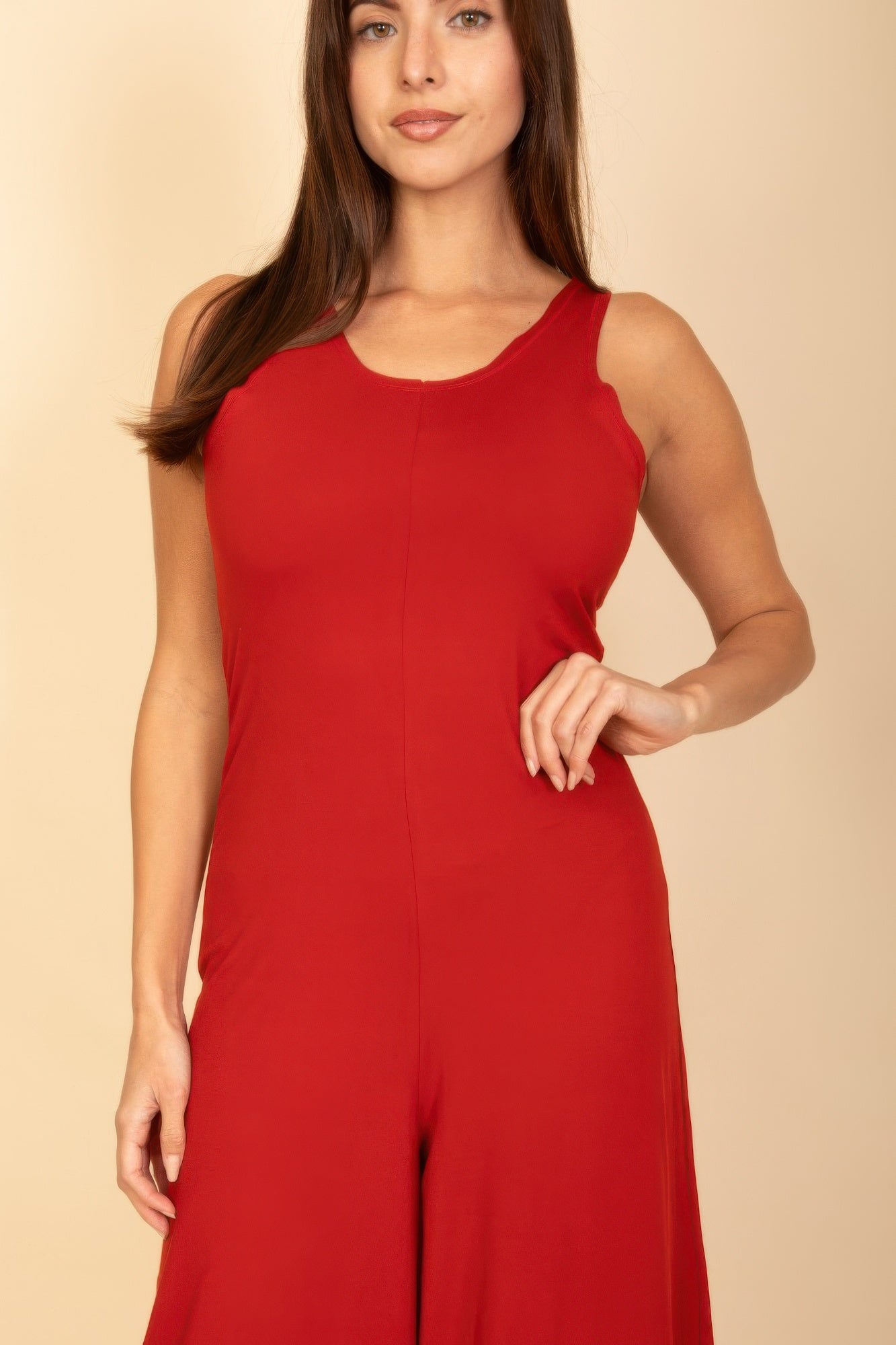 Red sleeveless jumpsuit close-up of scoop neckline and fitted bodice