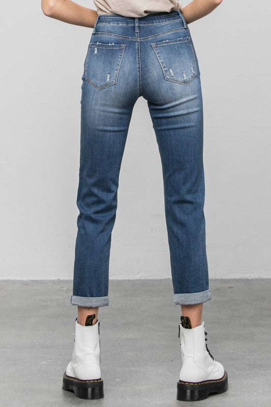 Dark slim boyfriend jeans, back view with two rear pockets and cuffed ankle hem.
