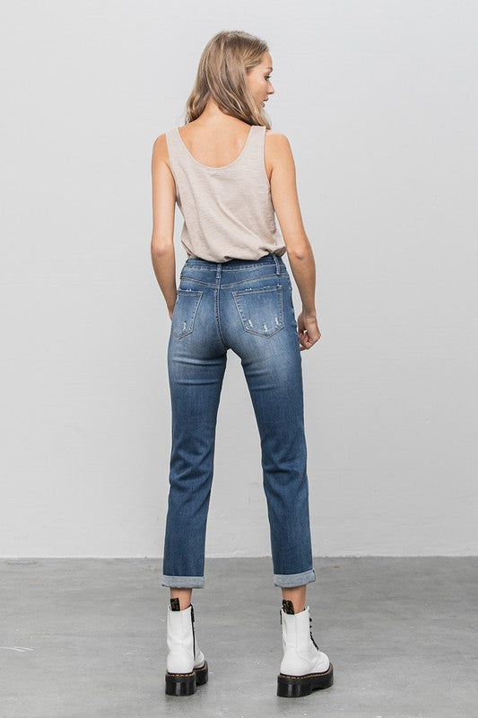 Dark slim boyfriend jeans, rear view with two back pockets and tapered straight fit.