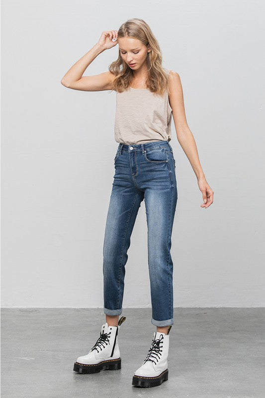 Dark slim boyfriend jeans, front side view with button fly, belt loops, and cuffed hem.