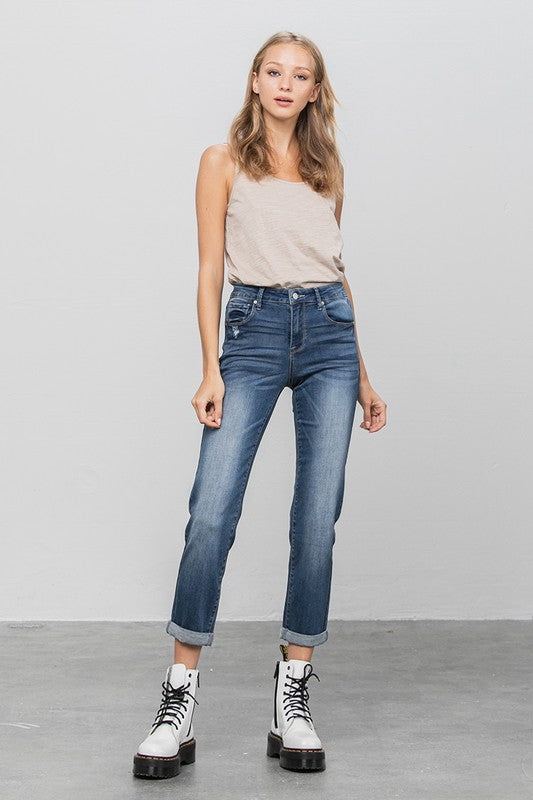 Dark slim boyfriend jeans, front view with button waistband and straight legs.