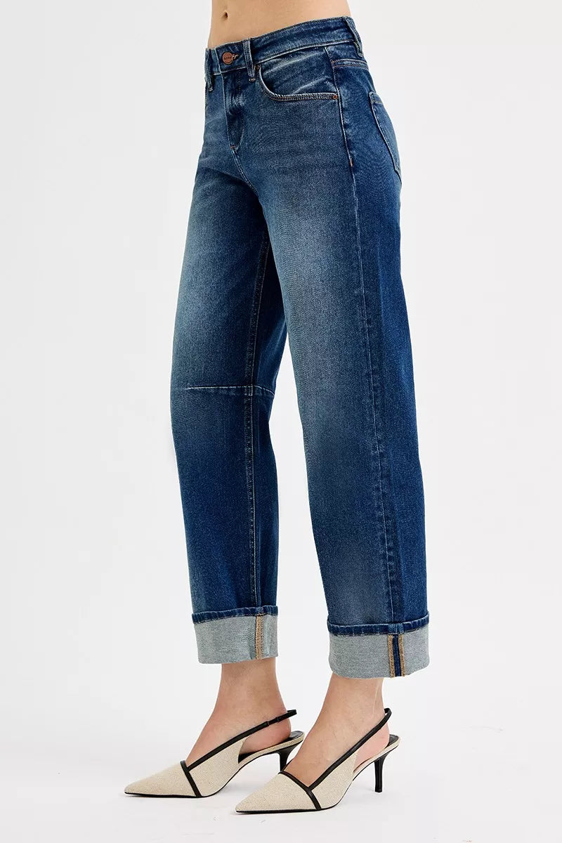Dark blue slouchy jeans with cuffed cropped hem, belt loops and front pockets