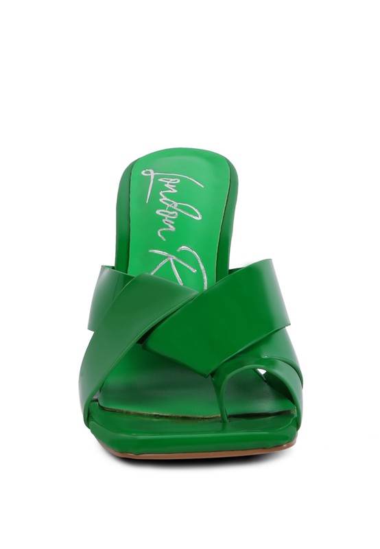Green heeled slide sandals with wide crisscross straps and open toe