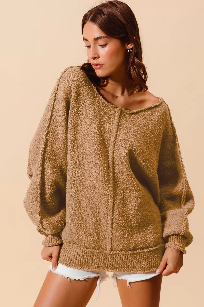 Taupe bouclé sweater with exposed vertical seam, loose fit, ribbed hem, dropped shoulder