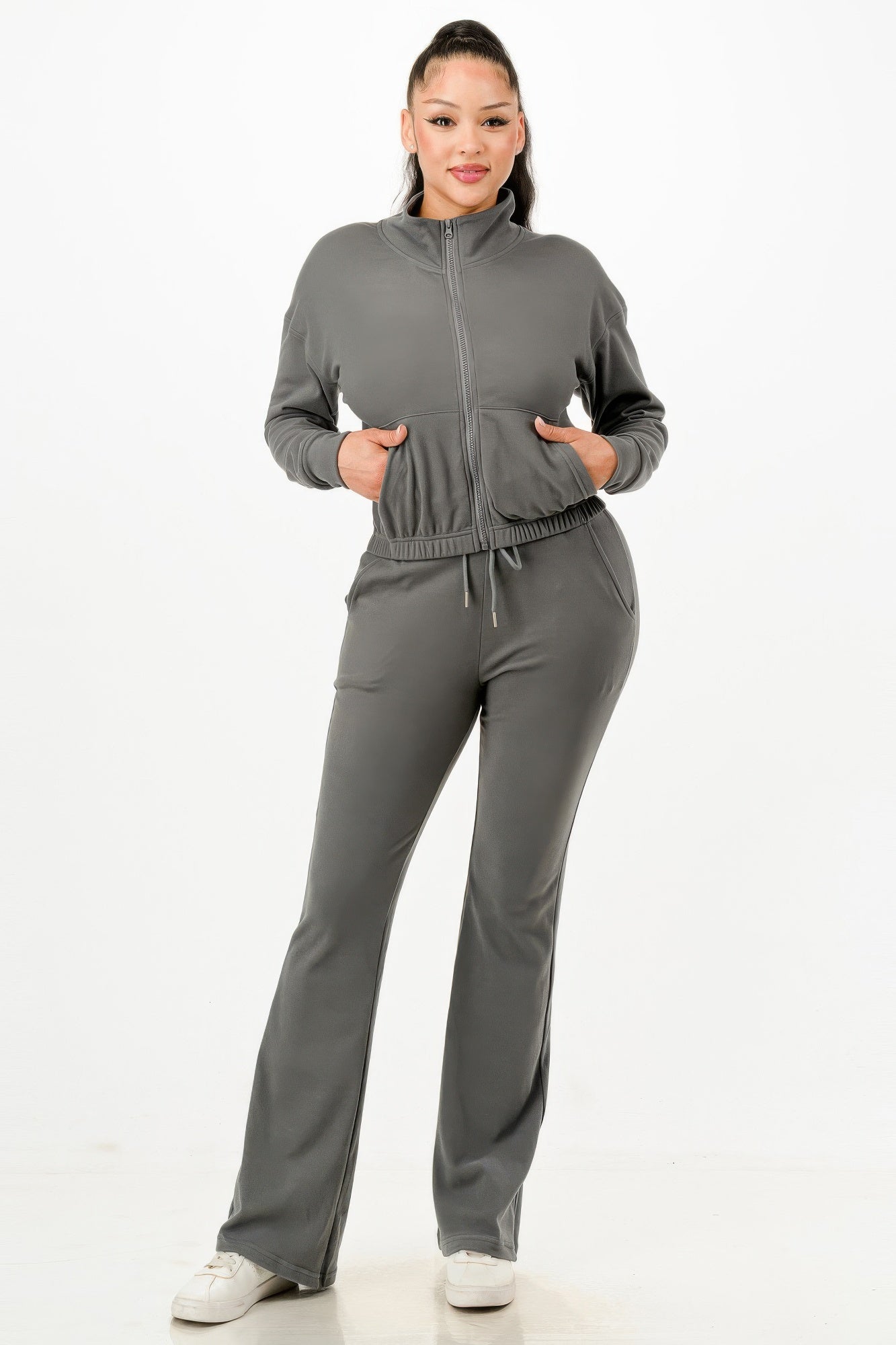 Gray zip-up track jacket and flared pants set with elastic waist and drawstring, front.