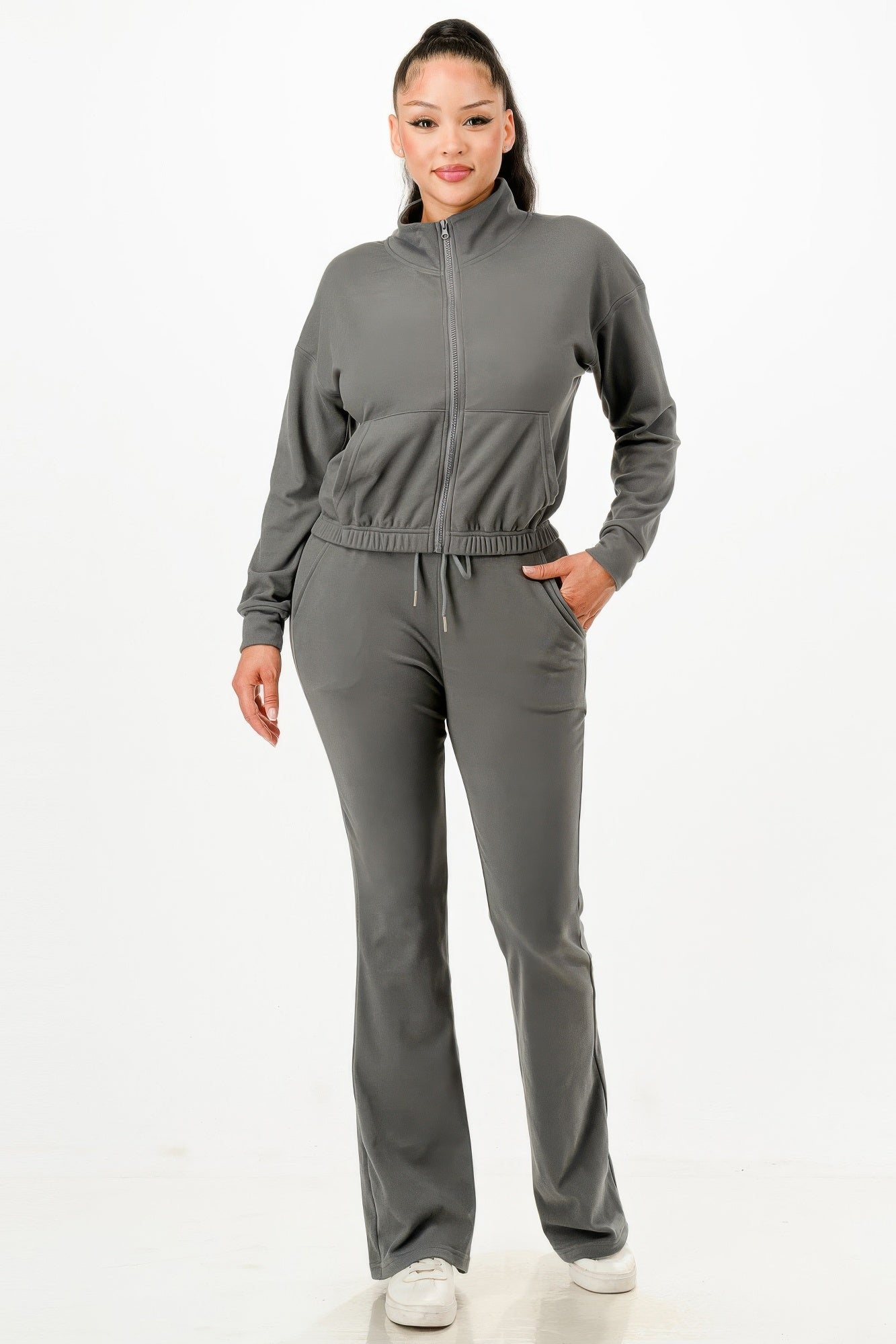Gray zip-up track suit set with high collar, elastic waistband, matching straight-leg pants.