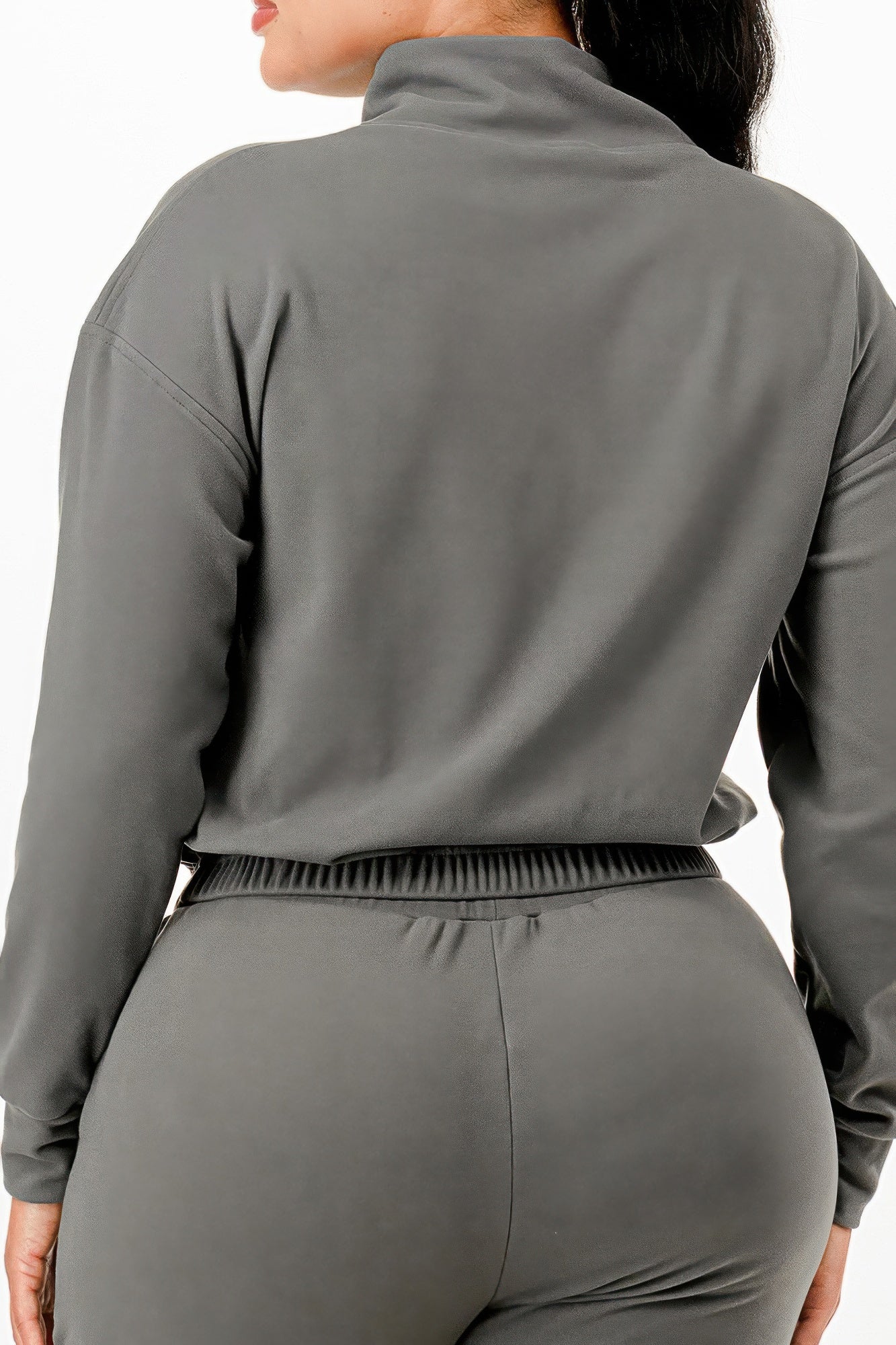 Back view of gray zip-up track suit set: smooth jacket back and elastic waistband.