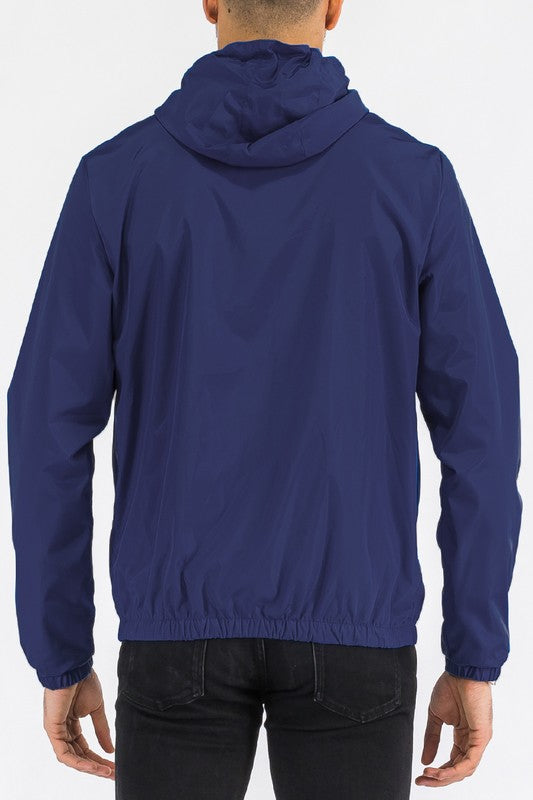 Navy lightweight windbreaker jacket, back view, with hood and elastic waistband.