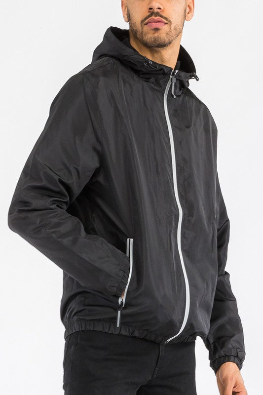 Black lightweight windbreaker jacket, front view, full-zip and drawstring-hood detail.