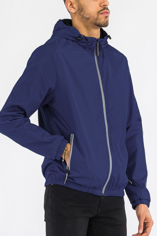 Navy lightweight windbreaker jacket sleeve detail with zip pocket and full-zip front.