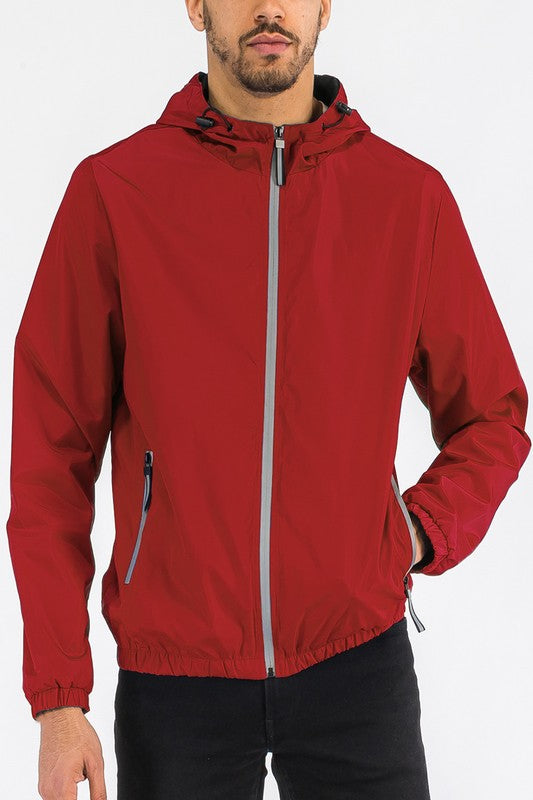 Red lightweight windbreaker jacket with hood, full-zip, and elastic cuffs and hem.